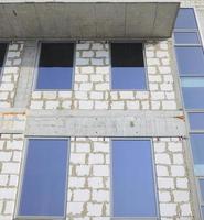 Fragment of an unfinished structure of a multi-storey building made of large concrete bricks photo