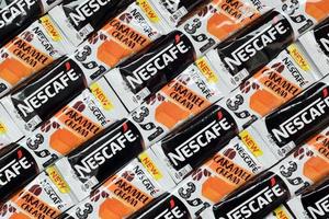 KHARKOV. UKRAINE - MAY 17, 2022 Many Nescafe caramel cream coffee sticks. Nescafe is a brand of coffee made by Nestle, swiss multinational conglomerate corporation photo