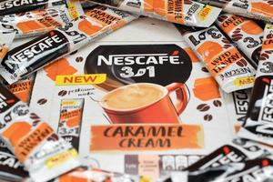 KHARKOV. UKRAINE - MAY 17, 2022 Many Nescafe caramel cream coffee sticks. Nescafe is a brand of coffee made by Nestle, swiss multinational conglomerate corporation photo