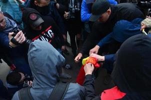 KHARKOV. UKRAINE - MAY 17, 2022 The organization of Ukrainian nazis and patriots of the Eastern Corps burns the flag of LGBT in Kharkov. Hooligans and ultras against the existence of minorities photo