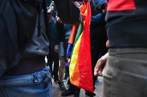 KHARKOV, UKRAINE - MAY 17, 2022 The organization of Ukrainian nazis and patriots of the Eastern Corps burns the flag of LGBT in Kharkov. Hooligans and ultras against the existence of minorities photo