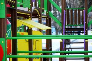 Fragment of a playground made of plastic and wood, painted in different colors photo