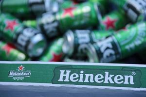 KHARKOV. UKRAINE - MAY 2, 2022 Green tin cans of Heineken lager beer produced by the Dutch brewing company Heineken N.V. photo