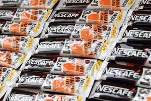 KHARKOV. UKRAINE - MAY 2, 2022 Many Nescafe caramel cream coffee sticks. Nescafe is a brand of coffee made by Nestle, swiss multinational conglomerate corporation photo