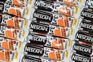 KHARKOV. UKRAINE - MAY 2, 2022 Many Nescafe caramel cream coffee sticks. Nescafe is a brand of coffee made by Nestle, swiss multinational conglomerate corporation photo