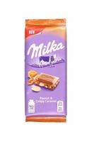 KHARKOV. UKRAINE - MAY 17, 2022 Purple Milka chocolate on white. Milka is a Swiss brand of chocolate confection manufactured internationally by company Mondelez International photo