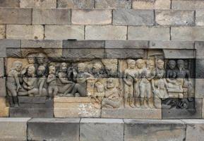 Borobudur, Indonesia, 2010 - Bas-relief sculptures on wall at encased foot of Borobudur, Indonesia photo