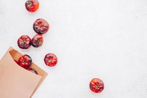 Tomatoes Mar Azul on white wooden table background photo