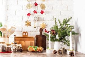 front view of the kitchen countertop with utensils and wooden boards, decorated for the holiday of the new year and Christmas. photo