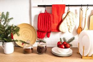 Front view part of a modern kitchen with eco-friendly items, utensils and green spruce branches.kitchen interior ideas decorated for the holiday. photo