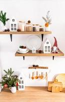 front view of the wooden countertop and shelves in the interior of the modern kitchen with utensils and Christmas decorations. ecologically kitchen. photo