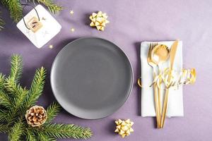 Beautiful top view of the New Year's empty plate. napkin with cutlery, Christmas decorations. a place to advertise your product. photo