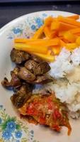 Top angle, fried chicken liver with chili sauce and boiled carrots as a side dish 03 photo