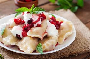 Delicious dumplings with cherries and jam. photo