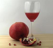 Pomegranate and pomegranate juice in a glass photo