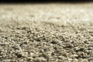 Close-up of beige fluffy carpet texture background, coffee-colored carpet background photo