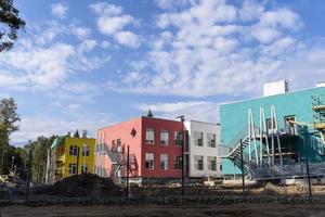 The progress of the construction of the kindergarten building. Colorful cheerful modern decoration of building facades photo