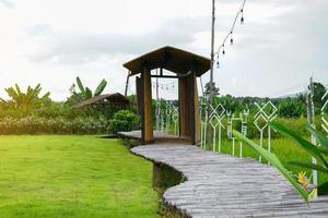 bamboo walkway  and bamboo arch, The resort uses to decorate the garden for people who stay to walk and see the nature. and trees around the resort. Soft and selective focus. photo