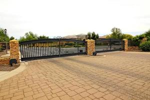 Entrance And Exit Gates With Pavers Driveway photo