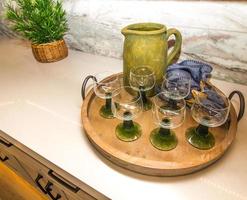 Serving Tray With Six Colored Glasses And Pitcher photo