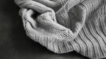 Selective focus Knitted Woolen, Knitwear Fabric Texture, Warm Clothes for Fall and Winter, Woven, Woolen, Sweaters, gray color with Dark Background and copy space photo