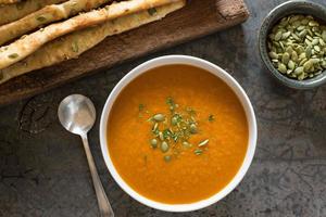 Pumpkin Soup in a Bowl with Bread Sticks photo