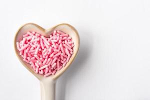 Pink Sprinkles in a Heart Shaped Spoon photo