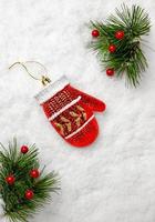 Holiday decorations. Glass Christmas tree toy red mittens in snow. concept of Christmas, copy space photo