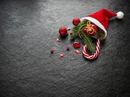 Fir branch, heart. caramel cane, in the hat of Santa Claus photo