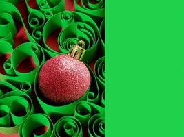New year's background, Christmas decorations. Christmas ball on the background of a paper pattern photo