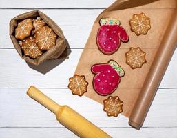 Cookies in bag and on parchment paper. Preparation of Christmas cookies of different shapes. new year's gifts photo