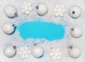 Christmas decorations white Christmas balls and snowflakes on soft snow, copy space photo