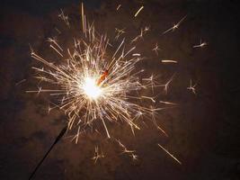 Sparkler candle lights. Bright sparks, fireworks fireworks. Concept of holiday, joy, New year, Christmas, birthday photo