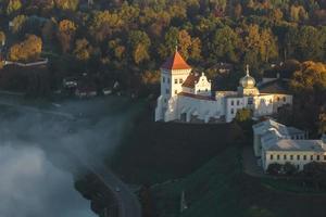 earlier foggy morning and aerial panoramic view on medieval castle and promenade overlooking the old city and historic buildings near wide river photo