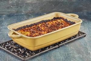Potato and sweet potato gratin with Provence herbs is baked in the oven. French gourmet cuisine photo