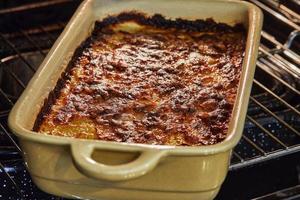 Potato and sweet potato gratin with Provence herbs is baked in the oven. French gourmet cuisine photo