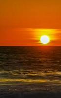 Colorful golden sunset big wave and beach Puerto Escondido Mexico. photo