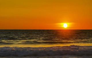 Colorful golden sunset big wave and beach Puerto Escondido Mexico. photo