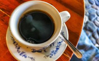 Blue white cup pot with black coffee wooden table Mexico. photo