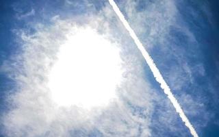 Blue sky with chemical clouds chemical sky chemtrails chemtrail. photo