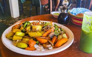 Fried rice and vegetables on white plate Puerto Escondido Mexico. photo