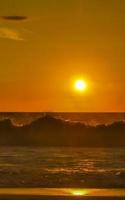 Colorful golden sunset big wave and beach Puerto Escondido Mexico. photo