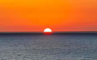 Colorful golden sunset big wave and beach Puerto Escondido Mexico. photo