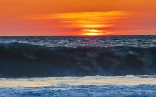 Colorful golden sunset big wave and beach Puerto Escondido Mexico. photo