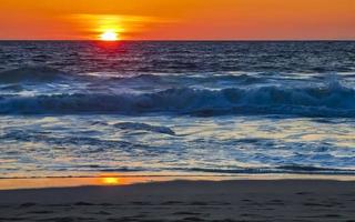 Colorful golden sunset big wave and beach Puerto Escondido Mexico. photo