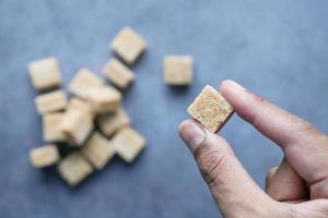 holding a brown sugar cube top view photo