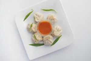 top view of chicken momo dumpling on a plate photo
