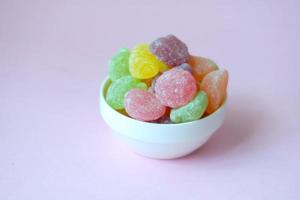 stack of sweet jelly in a bowl on pink photo