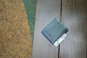 left wallet on a bench in the park photo