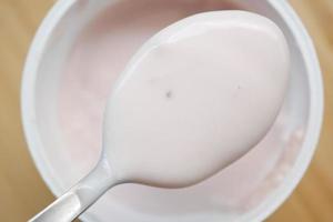 fresh yogurt on a spoon close up photo